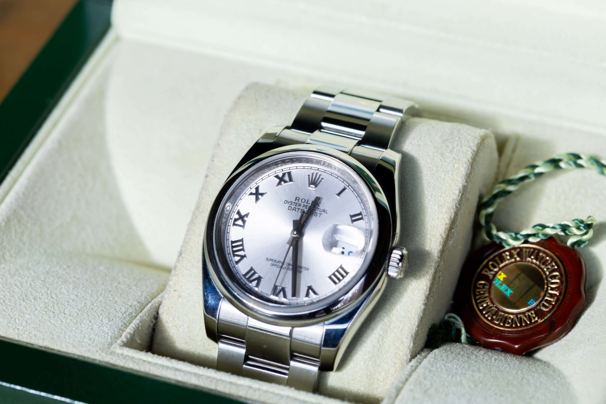 Rolex Datejust 36 full set displayed in a box, featuring a silver dial with Roman indices and Oystersteel case.