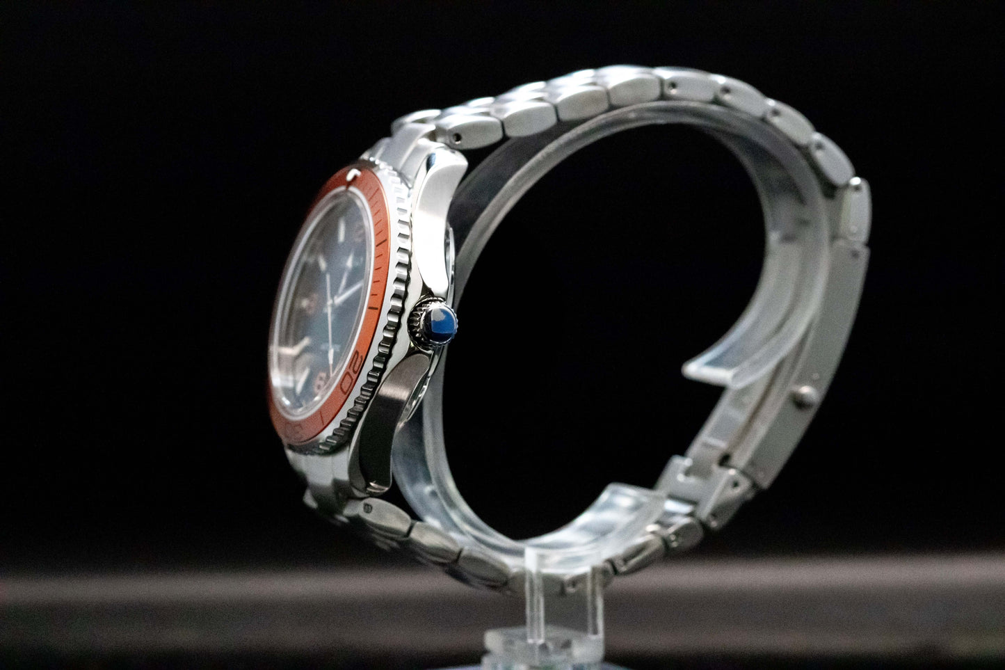 Seikomod Tiger Seamaster side view showcasing black dial, orange bezel, and stainless steel frame