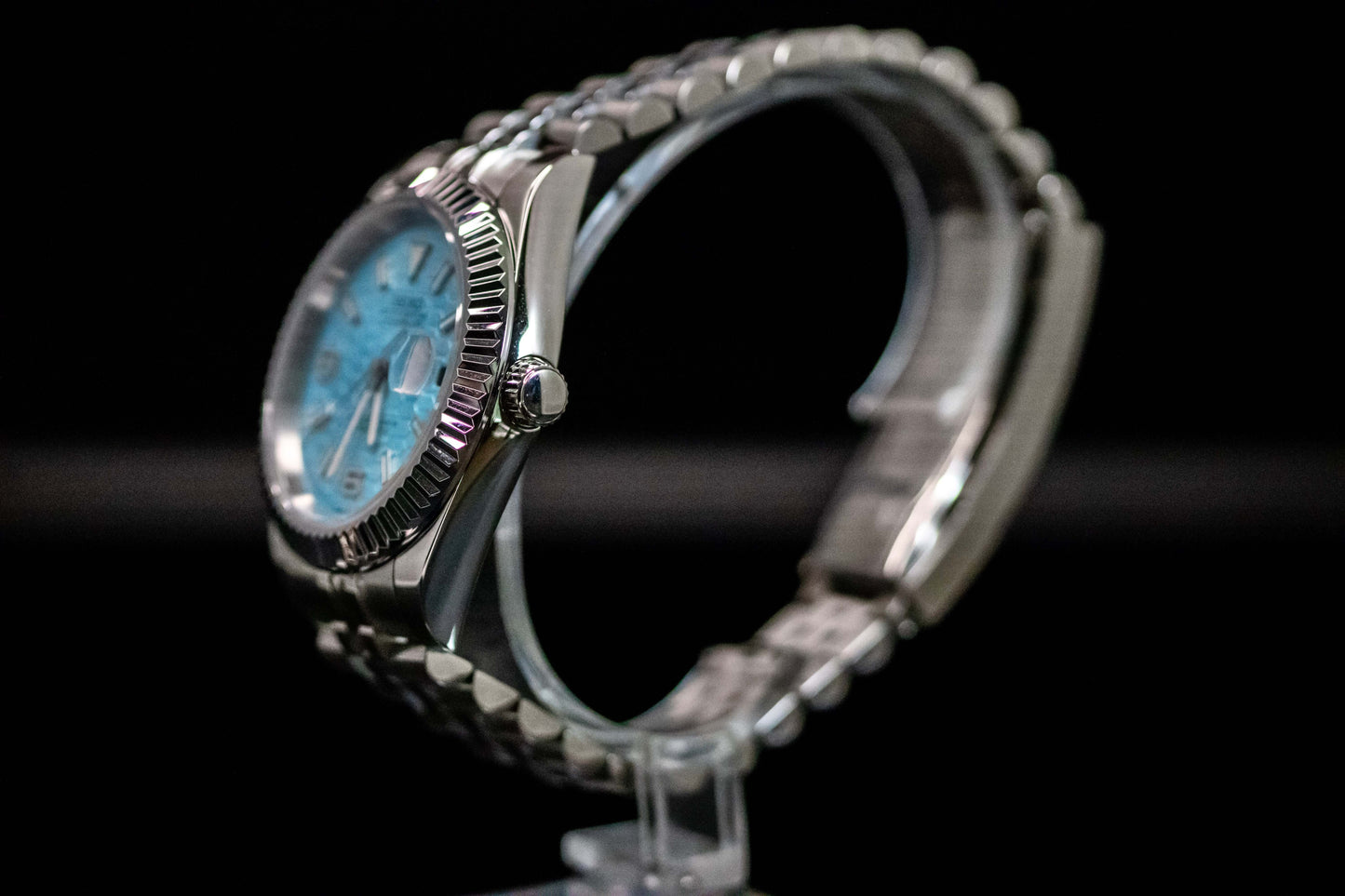 Ice Blue Seiko Mod Land Dweller watch with frosted metallic dial, side view showing brushed stainless steel case.