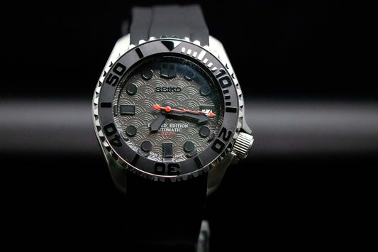 The Limited SKX homage watch with grey wave dial, black bezel, and red second hand for a sleek, sporty look.