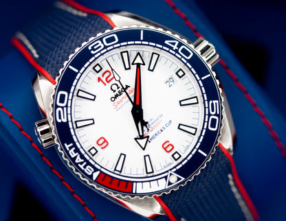 Omega Seamaster America's Cup watch close-up with white dial and blue accents.