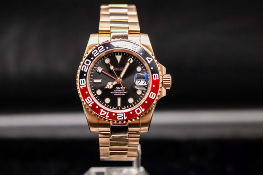 Seikomod Rose Gold Coke GMT watch with black dial and red bezel on a stainless steel bracelet.