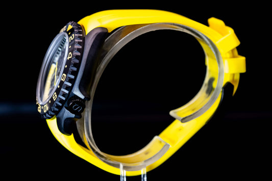 Side view of the Seikomod Yellow Skeleton SKX watch showcasing its vibrant yellow strap and sleek black bezel.