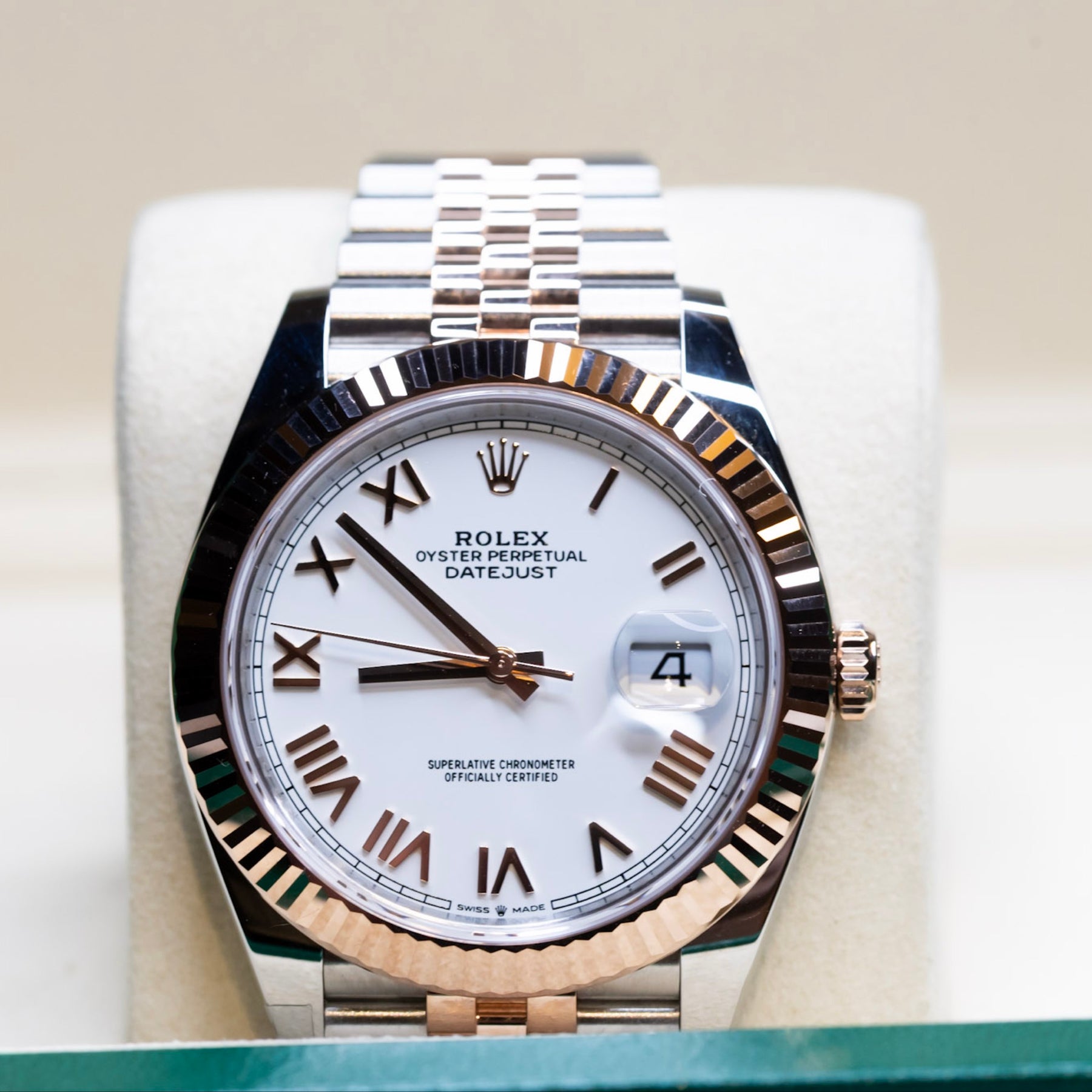 Brand New Unworn 2025 Rolex Datejust 41 rose gold watch on display with white dial and Roman numerals.