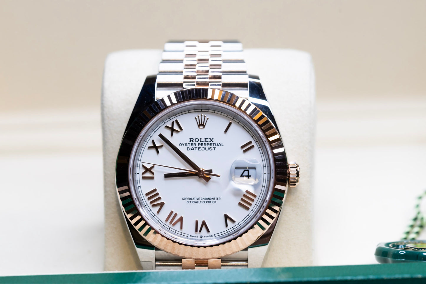 Brand New Unworn 2025 Rolex Datejust 41 rose gold watch on display with white dial and Roman numerals.