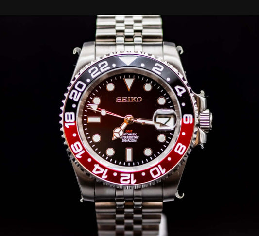 Seiko Coke GMT watch with NH34 automatic movement, black and red bezel, stainless steel case, and scratch-resistant sapphire crystal.