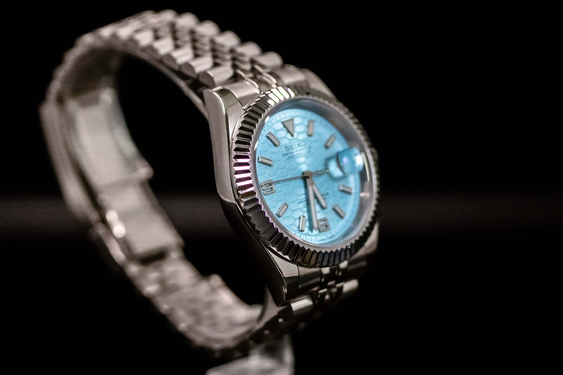 Ice Blue Seiko Mod Land Dweller watch with frosted metallic dial and stainless steel bracelet.
