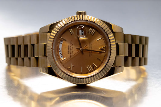 Seiko Mod Gold Day-Date watch with Champagne dial and fluted bezel, featuring a stylish President bracelet.