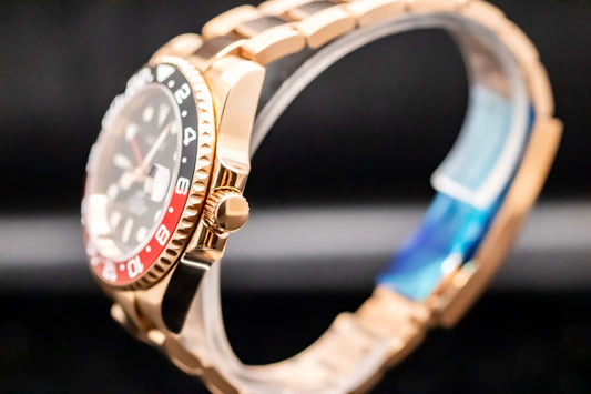 Close-up of the Seikomod Rose Gold Coke GMT watch showcasing its stainless steel case and striking dial.