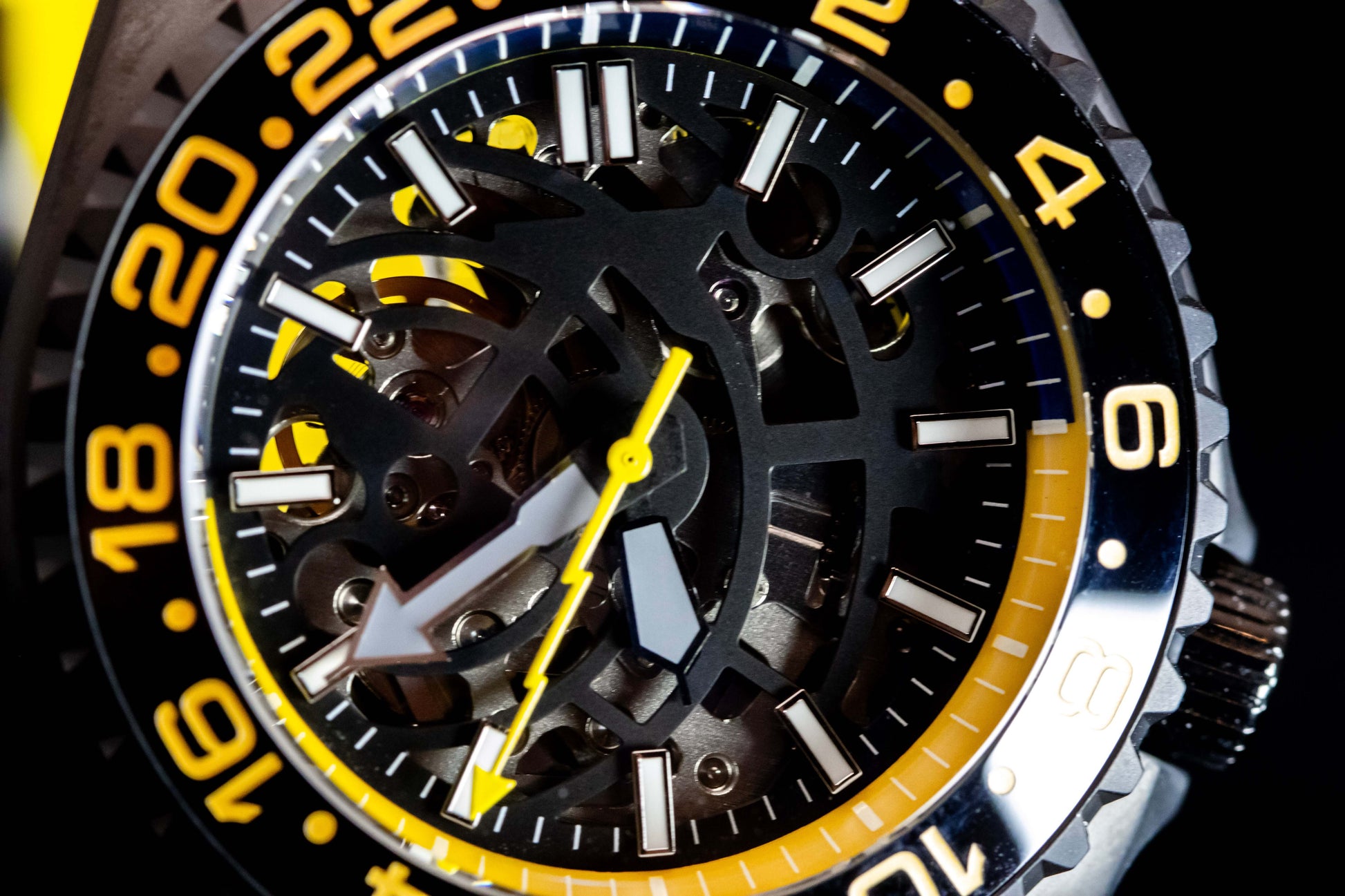 Close-up of Seikomod Yellow Skeleton SKX watch, showcasing its black and yellow design, skeleton dial, and bold accents.