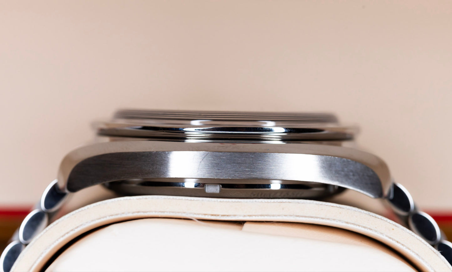 Omega Speedmaster Chronoscope stainless steel case profile on a leather cushion.
