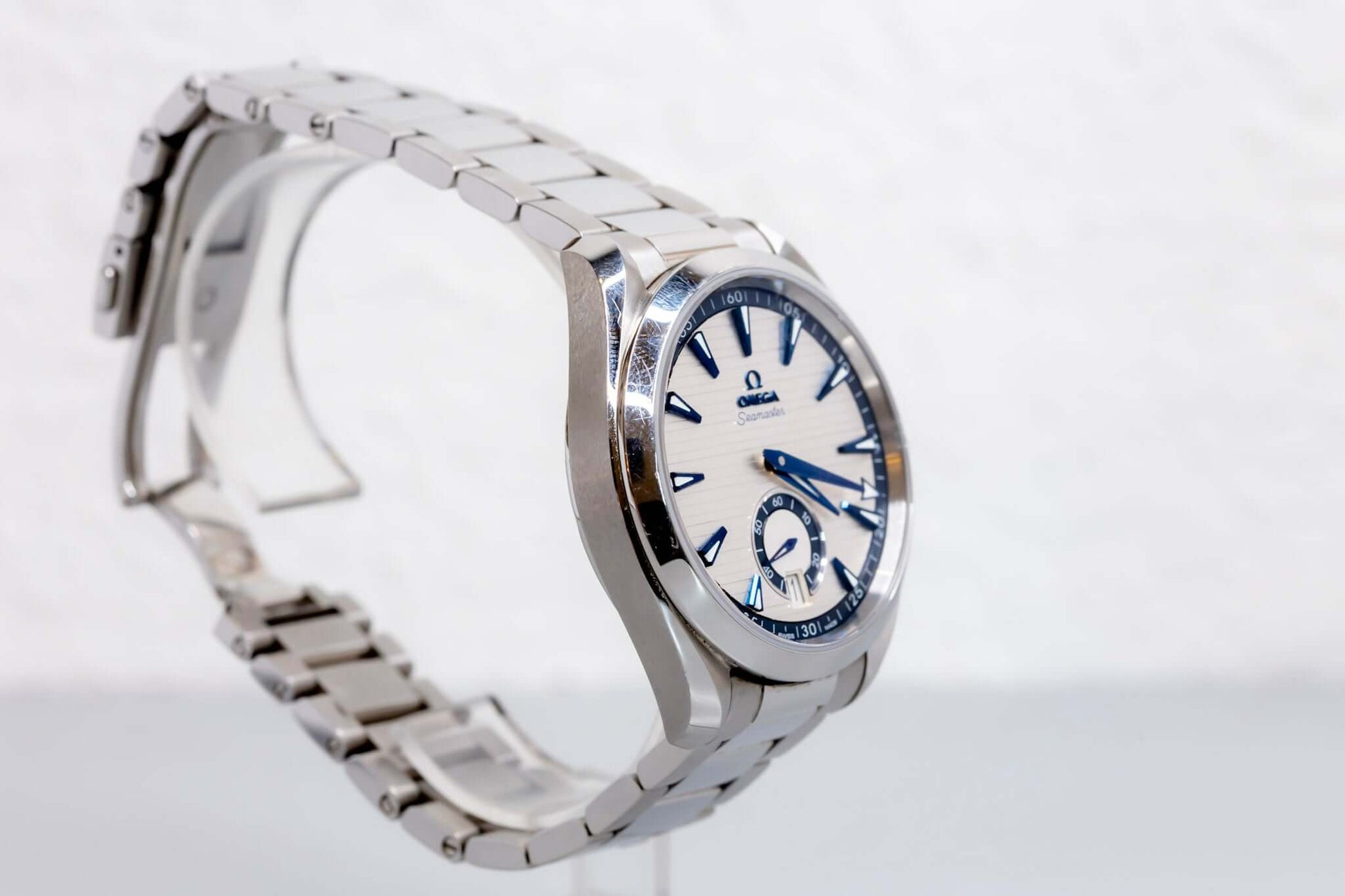 Omega Aqua Terra Small Seconds watch showcasing silver teak-pattern dial and stainless steel bracelet.