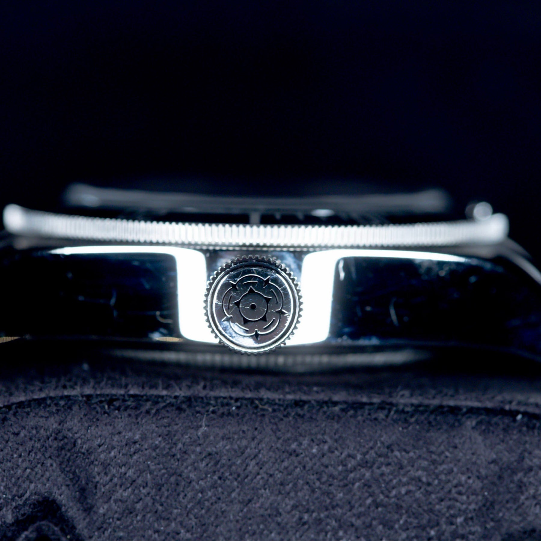 Close-up of the crown on a Tudor Black Bay Heritage 79230B watch, showcasing its distinctive design and finish.