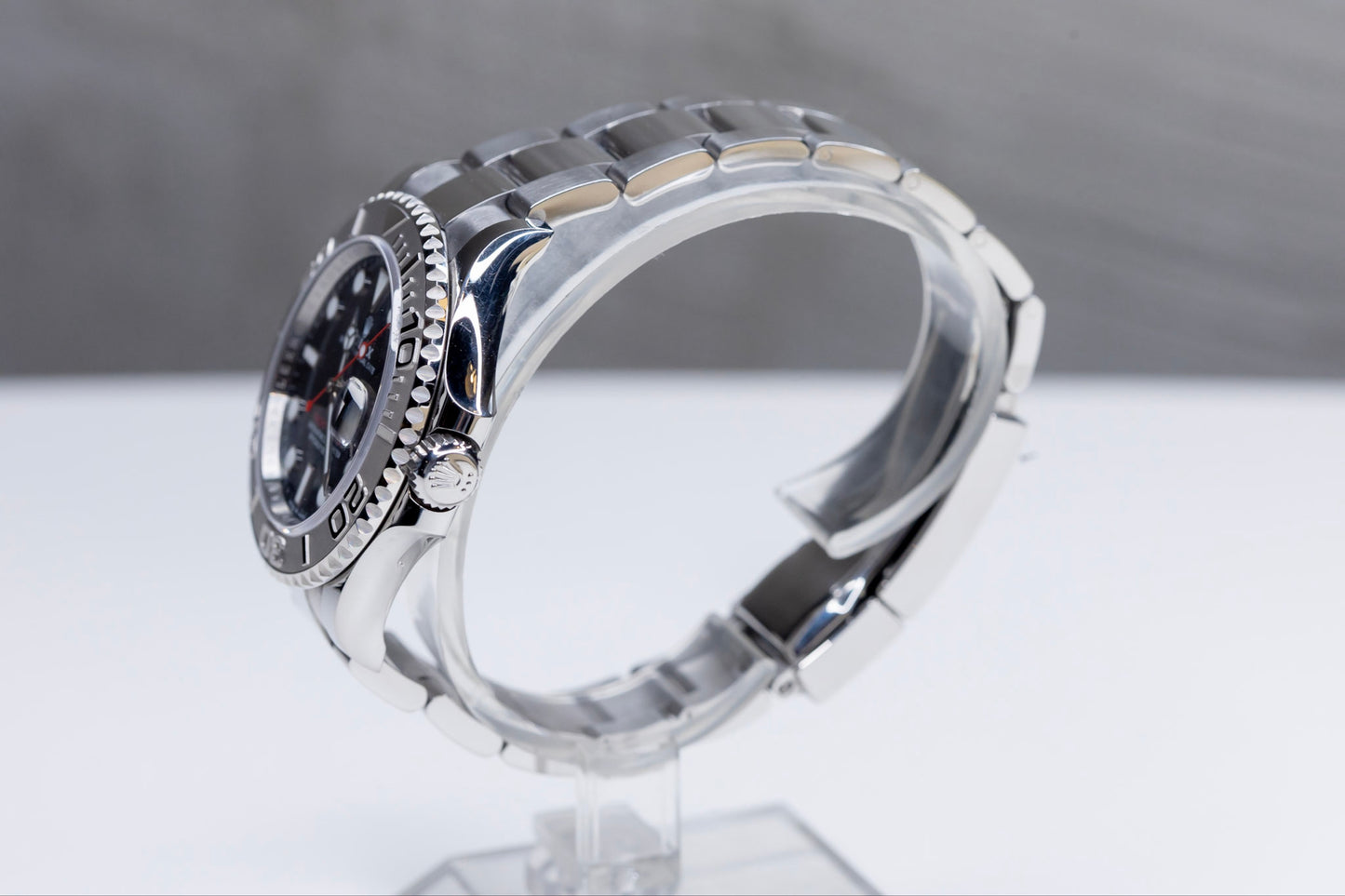 2024 Rolex Yachtmaster Superman side view showcasing the elegant design and Platinum bezel on a clear display stand.