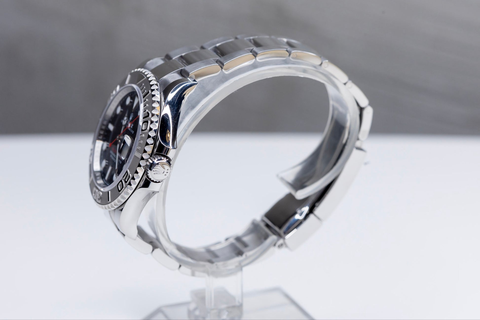 2024 Rolex Yachtmaster Superman side view showcasing the elegant design and Platinum bezel on a clear display stand.