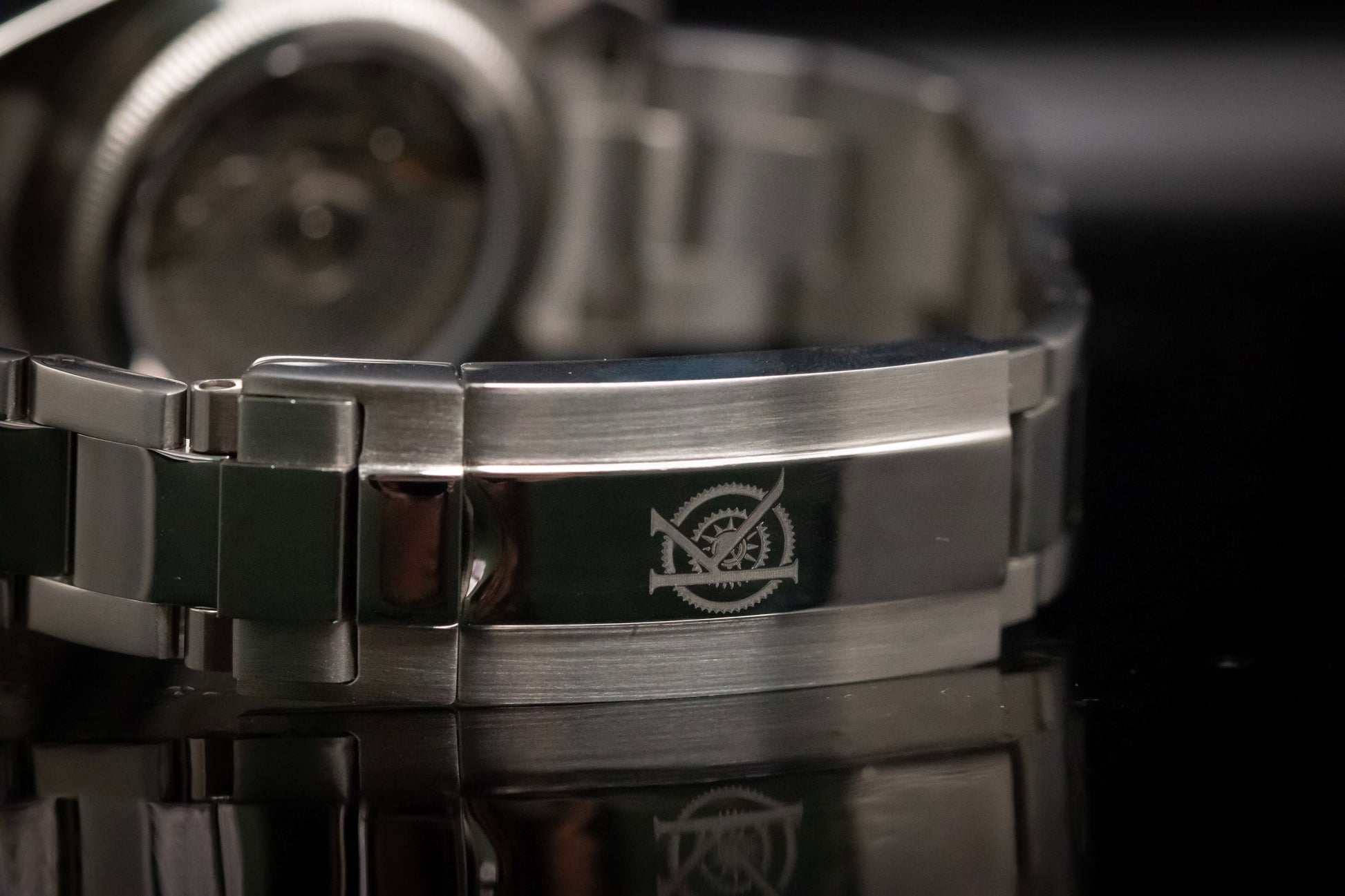 Close-up of Kingdom 7750 Automatic Chronograph's stainless steel bracelet with engraved logo.