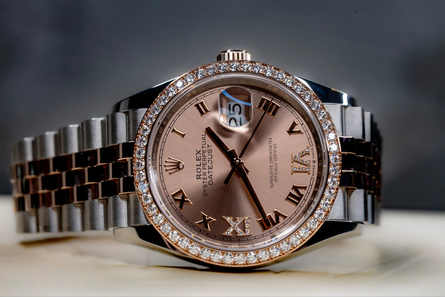 Rolex Datejust 36 watch with Everose gold and diamond bezel on a stylish bracelet.