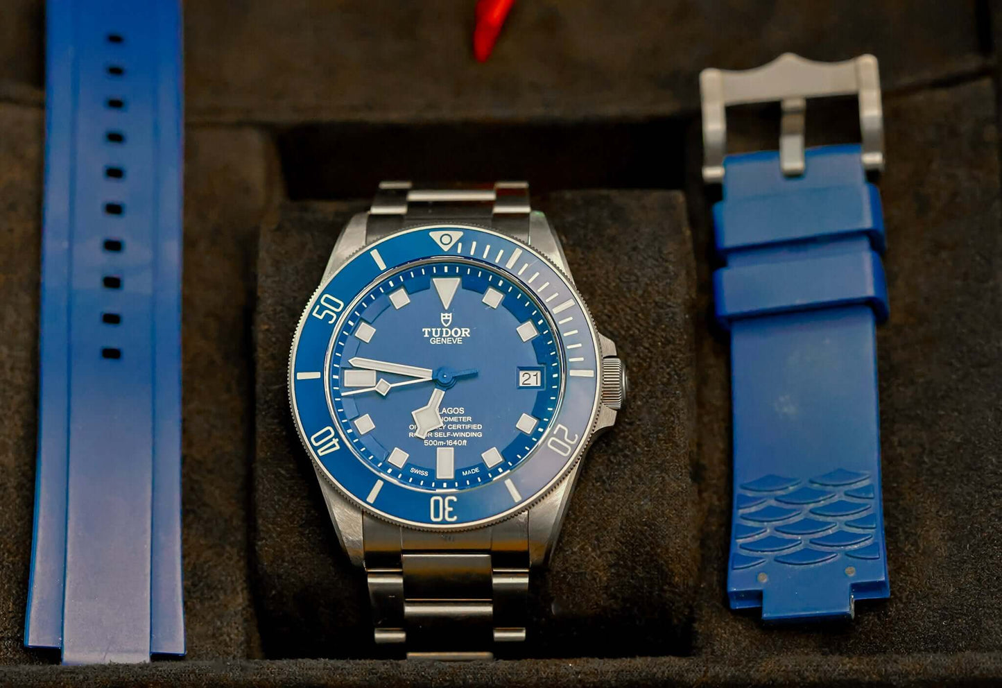 TUDOR Pelagos Titanium Diver watch - 42mm Blue Dial Diver – Full Set displayed with blue straps.