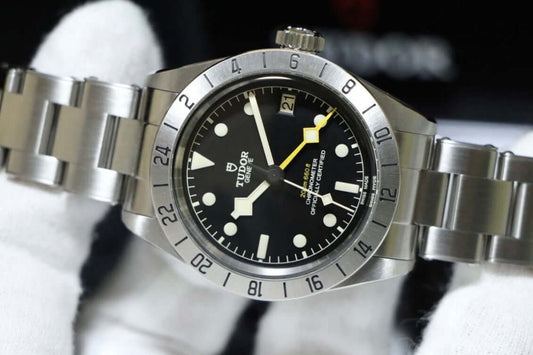 Tudor Black Bay Pro review showing the watch face, fixed steel bezel, and yellow GMT hand on a stainless steel bracelet.
