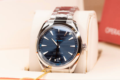 Omega Seamaster Aqua Terra 41mm watch with blue dial and stainless steel bracelet, showcased in luxury setting.