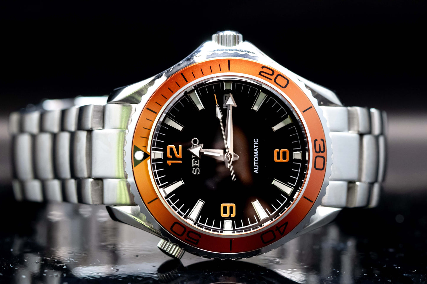 Seikomod Tiger Seamaster watch with black dial, orange numerals, and bezel in a stainless steel case.