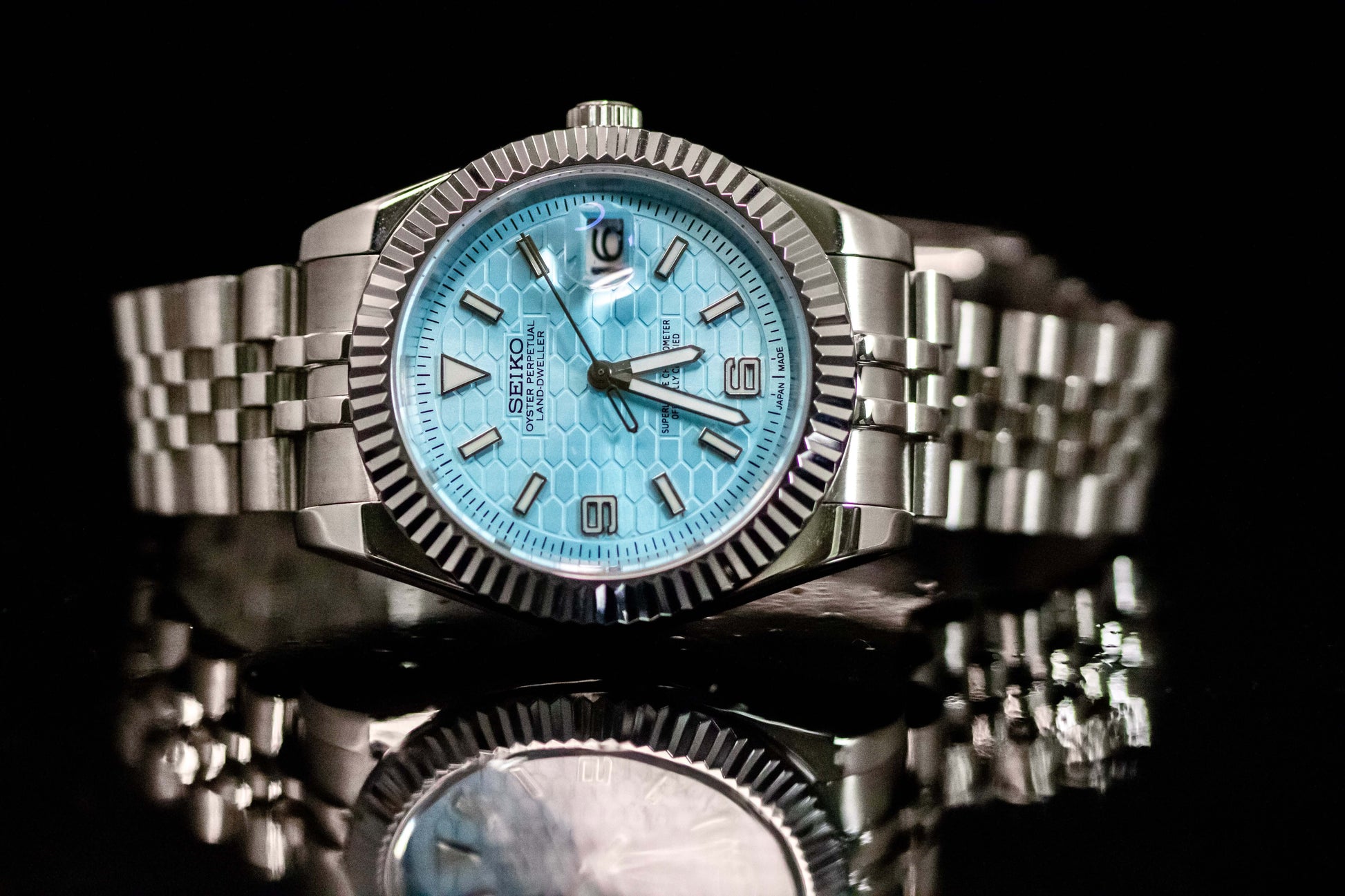 Ice Blue Seiko Mod Land Dweller watch with frosted metallic dial and stainless steel bracelet.