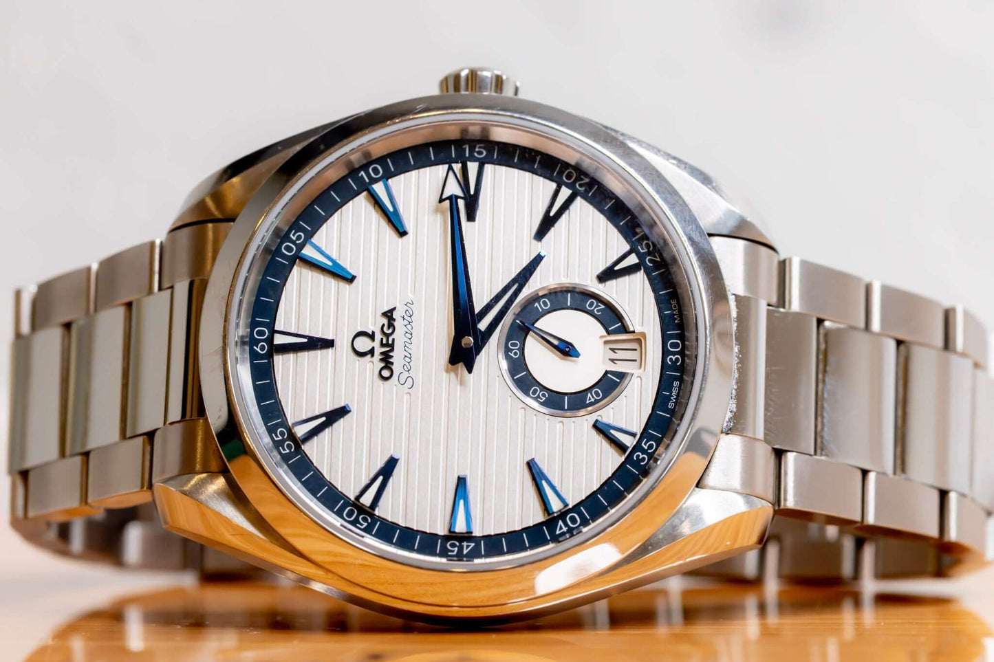 Omega Aqua Terra Small Seconds watch featuring a silver teak-pattern dial and stainless steel bracelet.