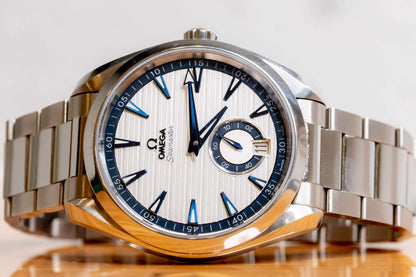 Omega Aqua Terra Small Seconds watch featuring a silver teak-pattern dial and stainless steel bracelet.