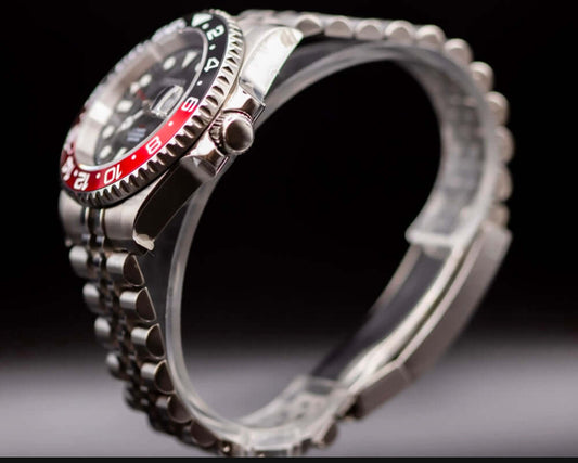 Side view of Seikomod Coke GMT watch showcasing its stainless steel case and red-black bezel.