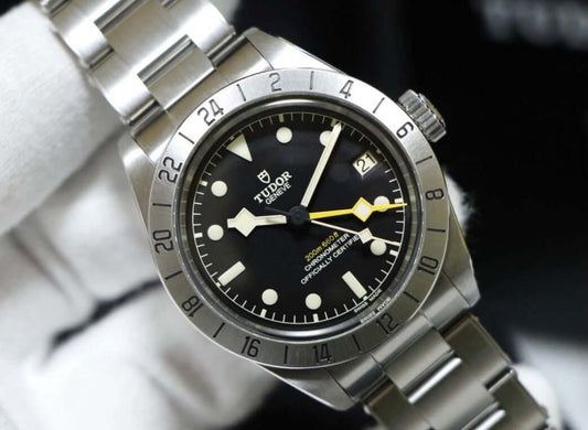 Tudor Black Bay Pro review watch with black dial and yellow GMT hand on stainless steel bracelet