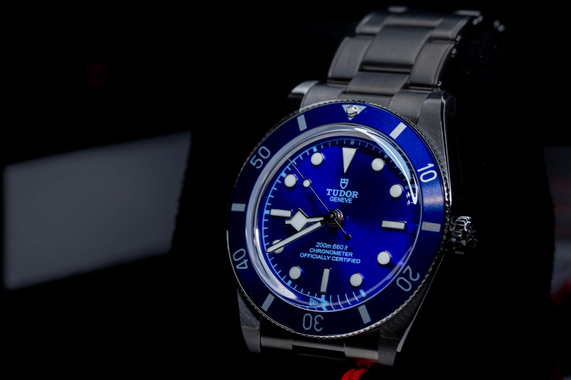 2026 Tudor Black Bay watch with blue dial and stainless steel bracelet displayed on black background.