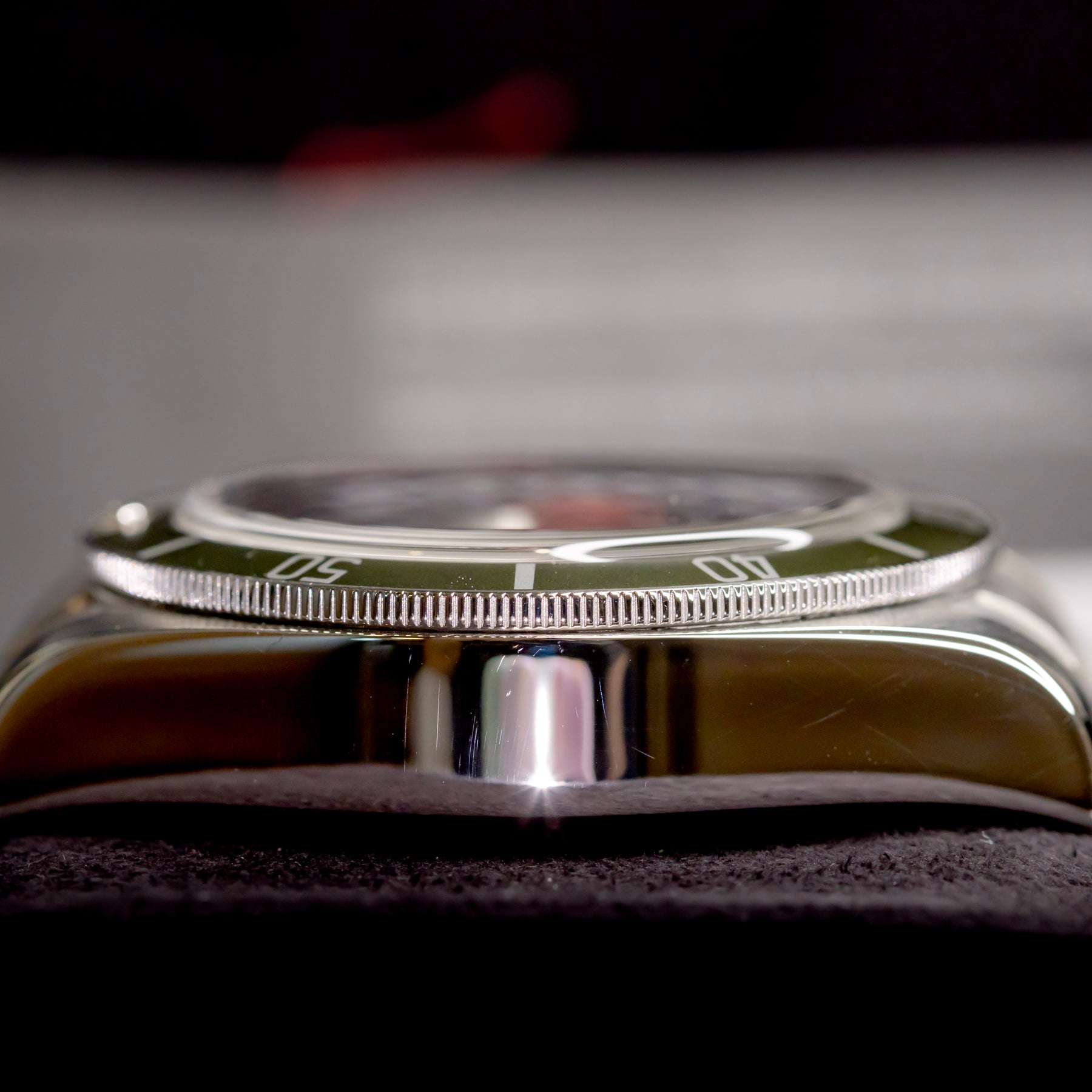 Tudor Black Bay Harrods Edition 41mm watch side view showcasing the green bezel and stainless steel case.