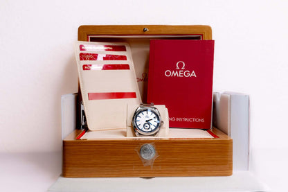 Omega Aqua Terra Small Seconds watch displayed in a wooden box with instructions and warranty cards.