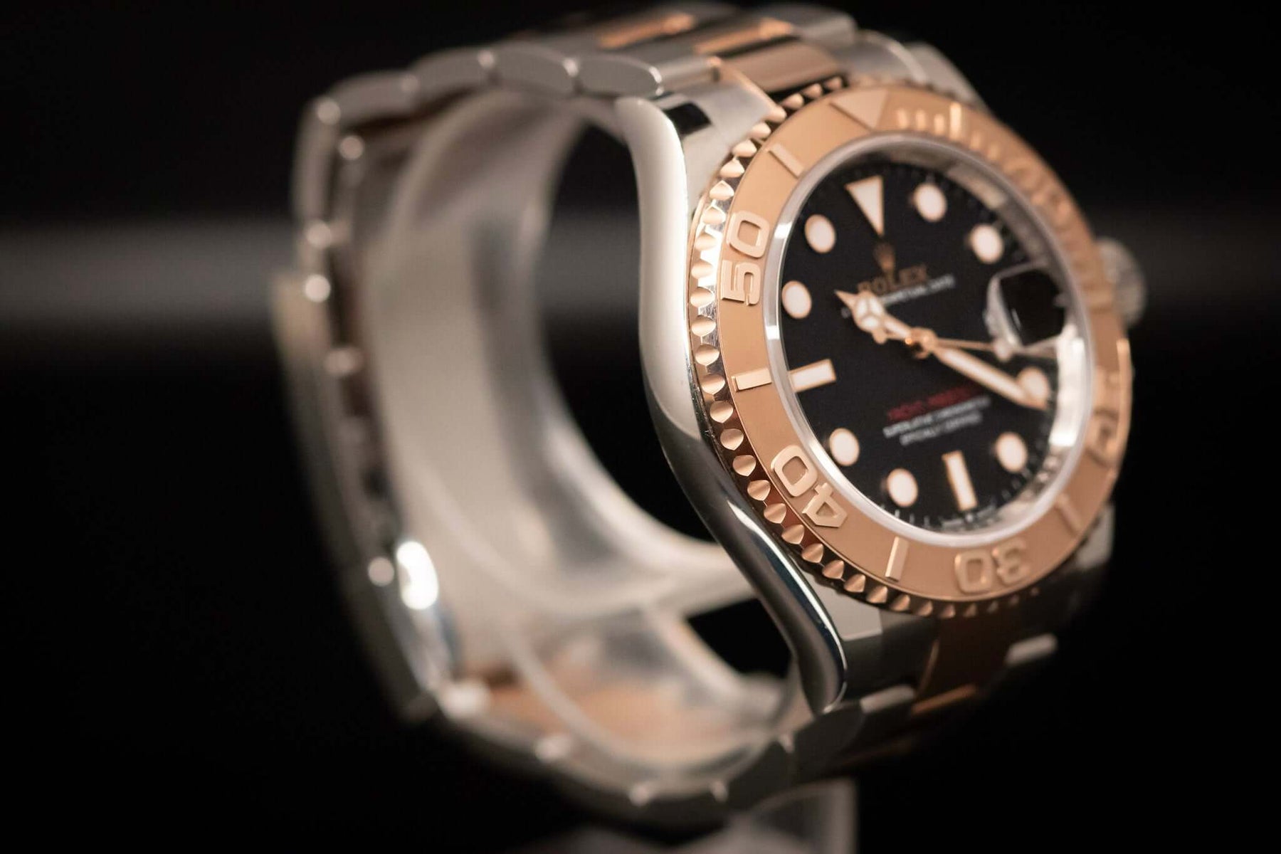 2023 Rolex Yacht-Master 40 watch close-up showing Everose gold and Oystersteel on a black dial