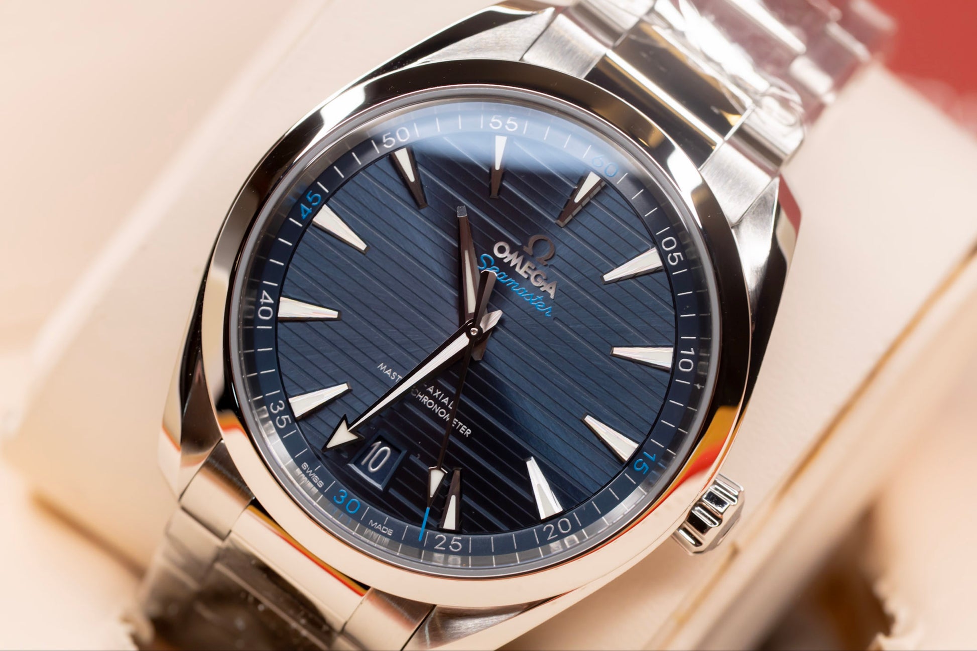 Omega Seamaster Aqua Terra 41mm watch with blue teak-pattern dial and stainless steel bracelet.