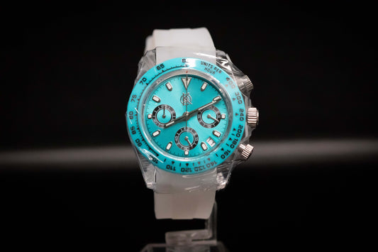 KWC Ice Ceramic Chronograph watch with turquoise dial and white strap on display.