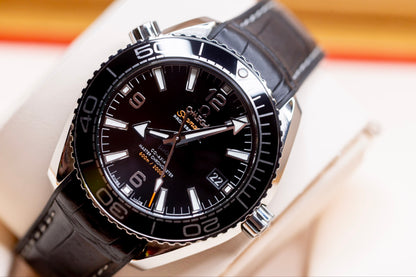 2023 Omega Seamaster Planet Ocean full set with black dial and leather strap, featuring luminous markers.