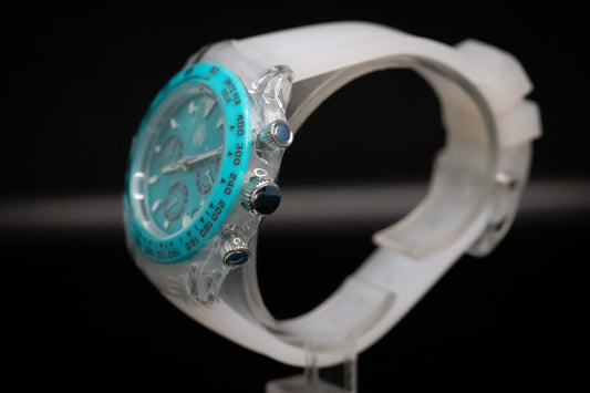 KWC Ice Ceramic Chronograph watch featuring a turquoise dial and clear case.