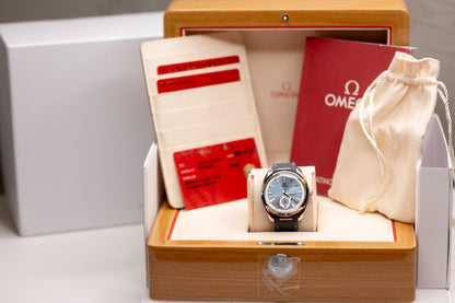 Omega Seamaster Aqua Terra 150M blue dial displayed in luxury wooden box with papers and pouch.
