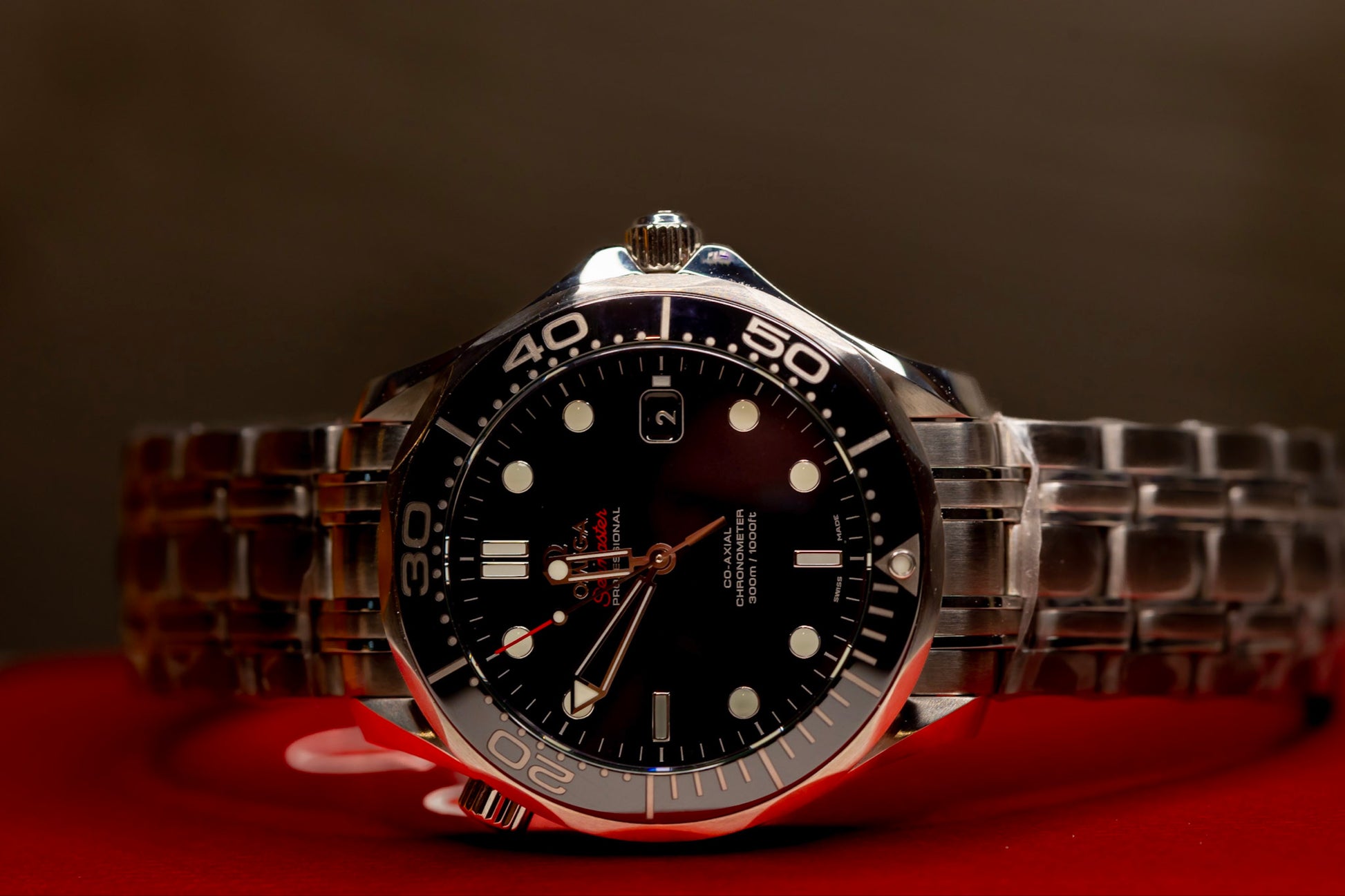 Omega Seamaster Diver original box papers, showcasing a sleek stainless steel wristwatch with black dial.