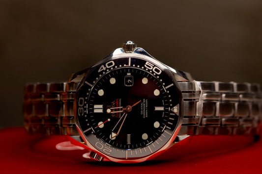 Omega Seamaster Diver original box papers, showcasing a sleek stainless steel wristwatch with black dial.