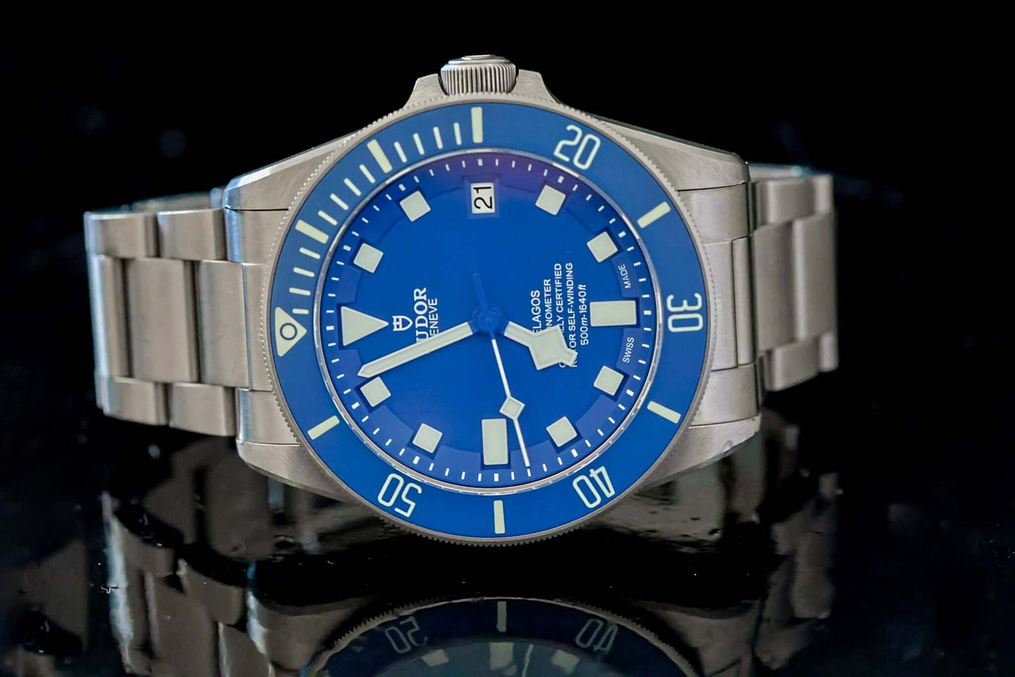 TUDOR Pelagos Titanium Diver watch - 42mm Blue Dial Diver – Full Set displayed on a reflective surface.
