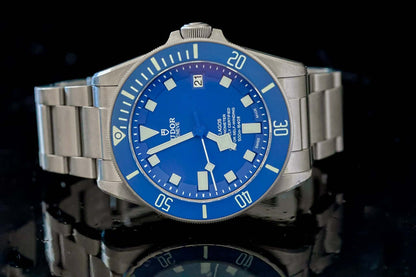 TUDOR Pelagos Titanium Diver watch - 42mm Blue Dial Diver – Full Set displayed on a reflective surface.