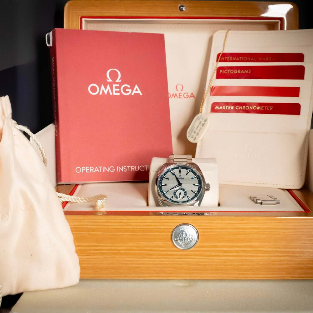 Omega Seamaster Aqua Terra 41mm Silver Dial – Ref. 220.10.41.21.02.004 displayed with operating instructions and packaging.