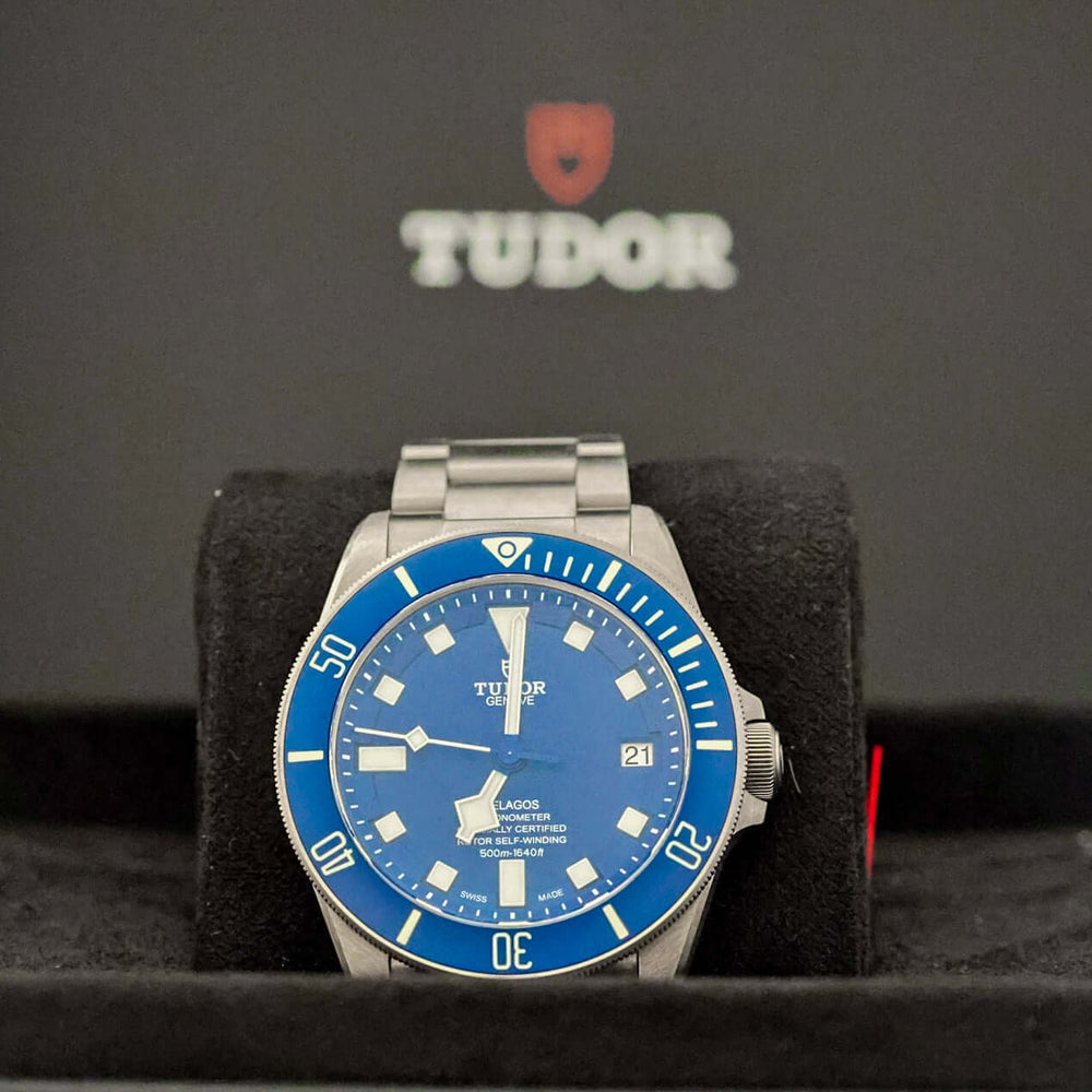 TUDOR Pelagos Titanium Diver watch - 42mm Blue Dial Diver – Full Set displayed on a plush black watch holder.