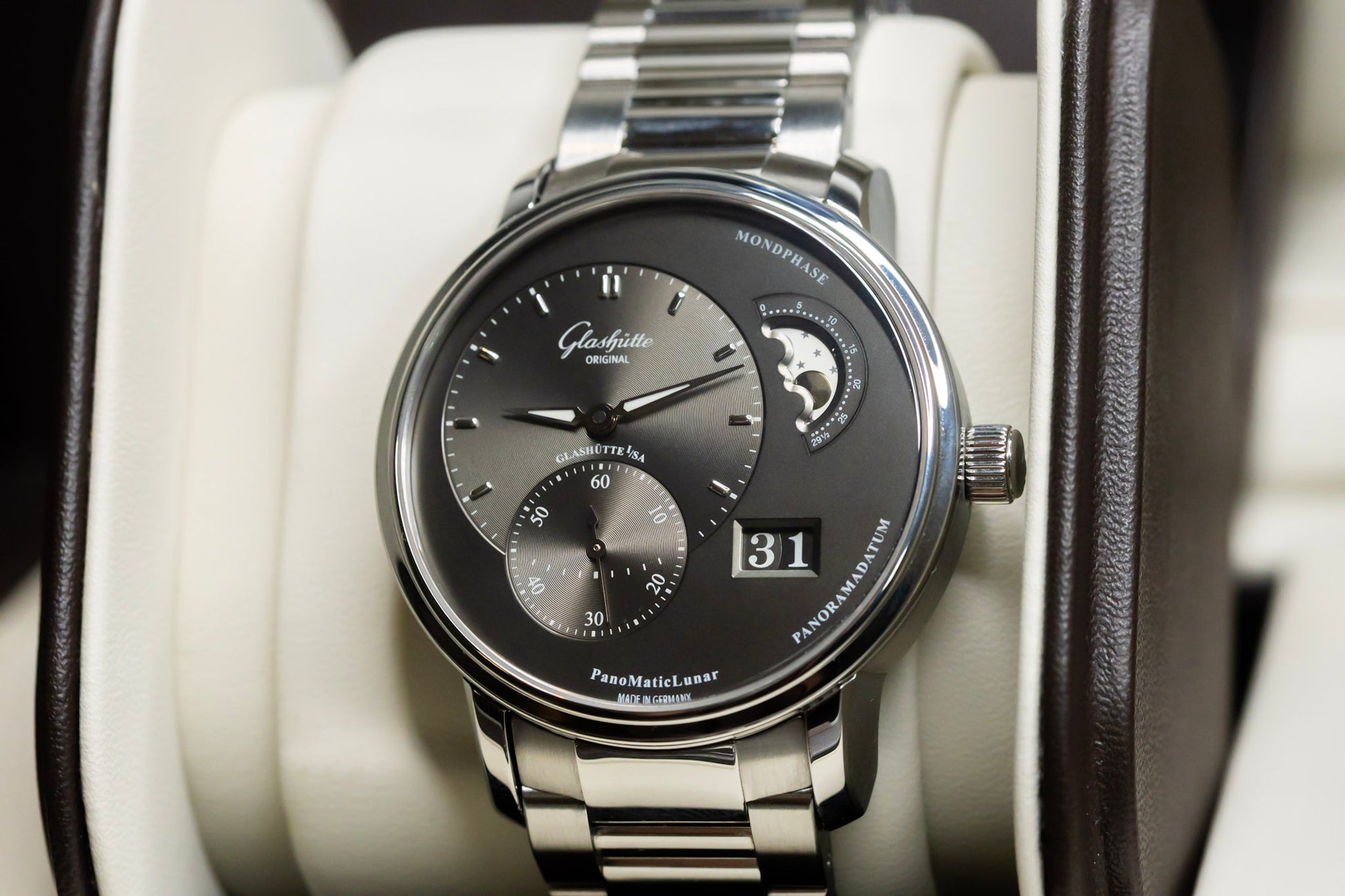 Glashütte Original PanoMaticLunar watch displayed in luxury case with stainless steel bracelet and moonphase feature.