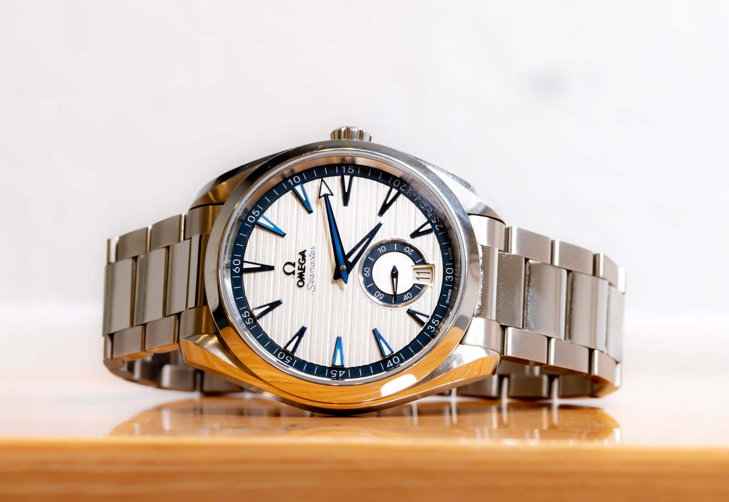 Omega Aqua Terra Small Seconds watch with silver teak-pattern dial and stainless steel bracelet.