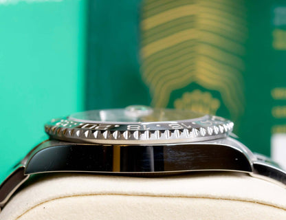 2025 Rolex GMT-Master II Bruce Wayne 126710GRNR-0004 side view showing the bezel and bracelet on display.