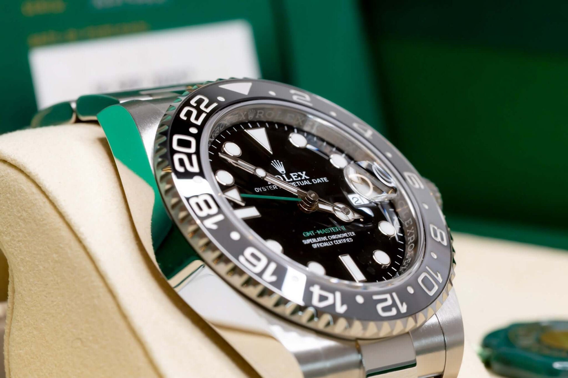 2025 Rolex GMT-Master II Bruce Wayne showcasing black dial and ceramic bezel, displayed elegantly on a plush cushion.