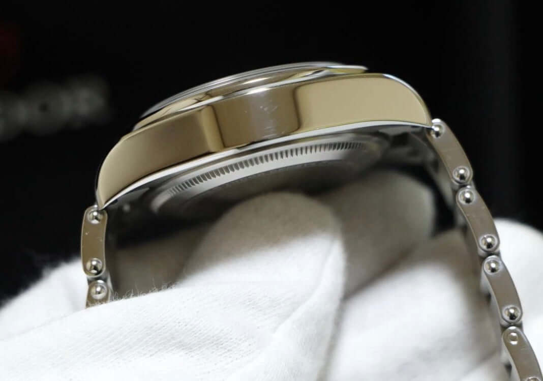 Tudor Black Bay Pro review showing the side profile of the watch case and bracelet with a white glove.
